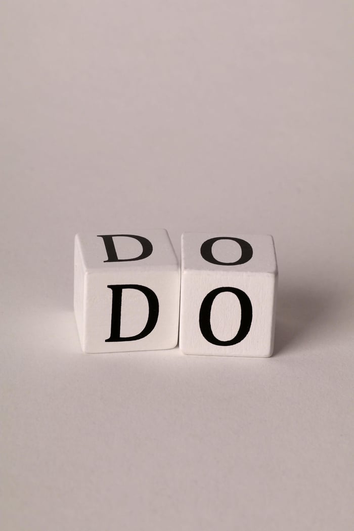 A detailed close-up of two dice with the letters D and O on a plain white background.