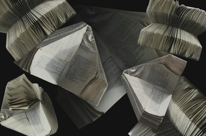 An abstract display of folded vintage books showcasing their pages and textures.